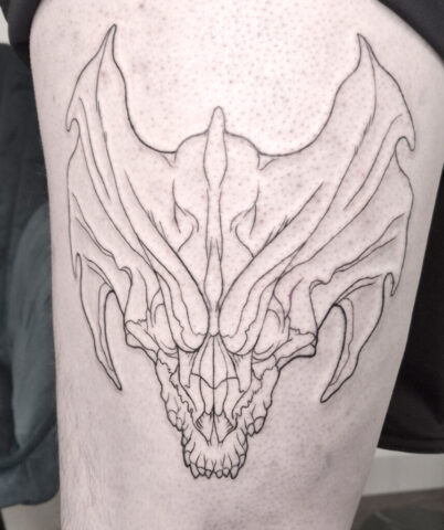 Tattoo eines Messingdrachen Schädels